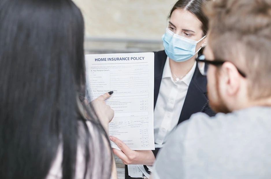 A team of professional consultants reviewing architectural blueprints in a modern office.